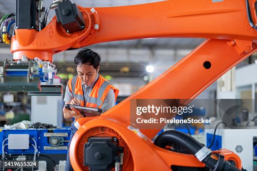 Japanese Engineer Inspecting The Robotic Collaborative Conveyor