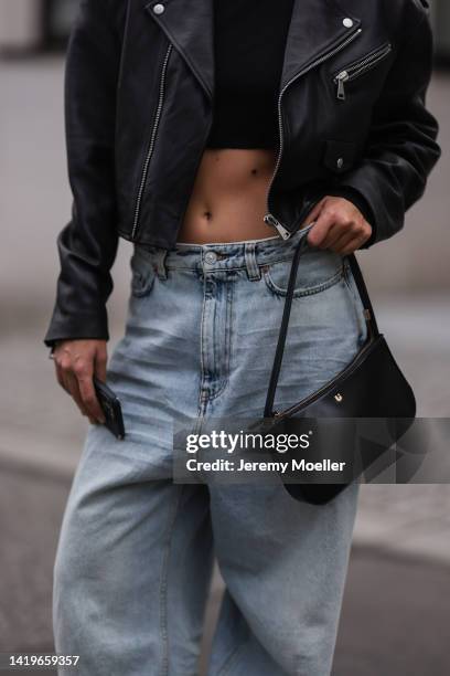 Alessa Winter wearing Balenciaga x Crocs black sandals, Balenciaga wide leg oversized baby blue denim pants, Liu Jo black leather bag, Chanel vintage...