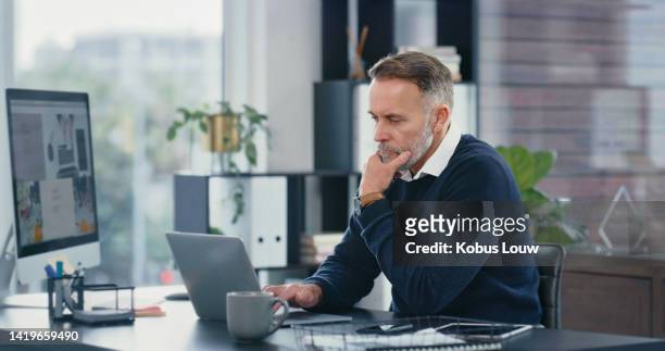 corporate accountant working on a laptop and computer doing accounting research in a modern office. businessman analyzing stocks, stats and finance economy to create financial freedom with technology - vrijwilliger bedrijf stockfoto's en -beelden