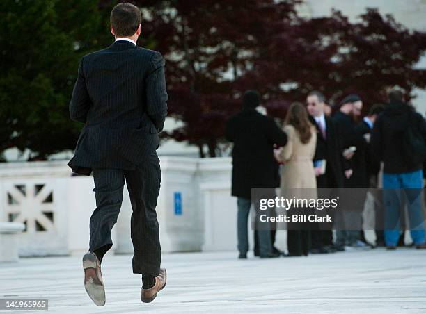 Rep. Aaron Schock, R-Ill., runs across the plaza of the Supreme Court at 9:59AM to attend hear the court's arguments on the health care reform bill,...