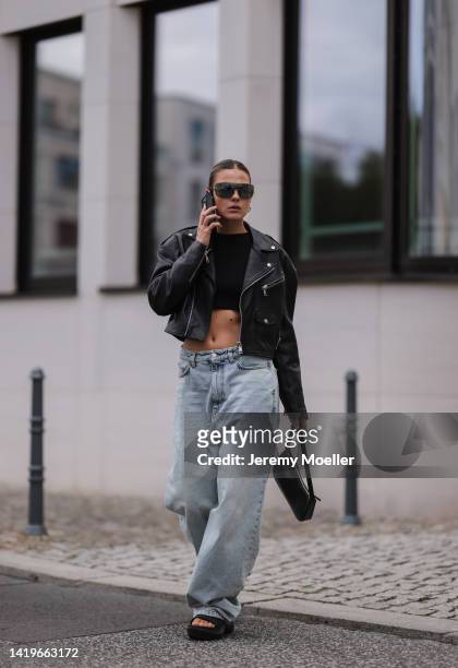 Alessa Winter wearing Balenciaga x Crocs black sandals, Balenciaga wide leg oversized baby blue denim pants, Liu Jo black leather bag, Chanel vintage...