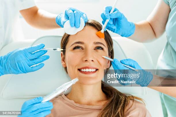 beautiful smiling woman having various facial treatment - ácido hialurónico imagens e fotografias de stock