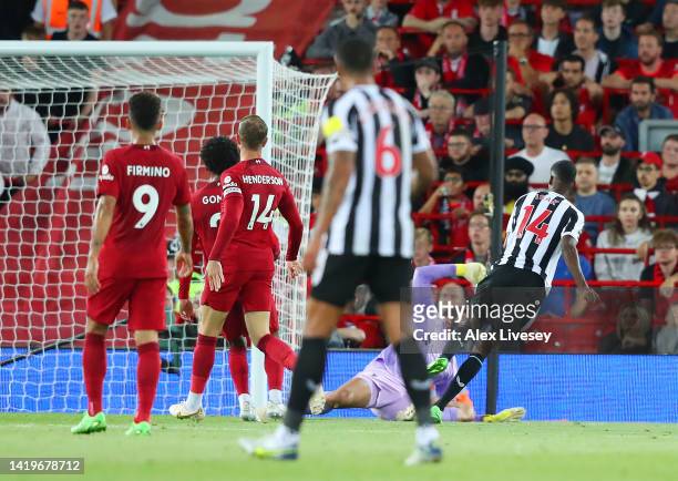 Alexander Isakof Newcastle United scores their side's first goal as Alisson Becker of Liverpool attempts to make a save during the Premier League...