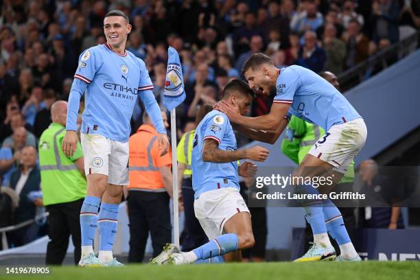 Joao Cancelo celebrates with Ruben Dias and Phil Foden of Manchester City after scoring their team's fourth goal during the Premier League match...