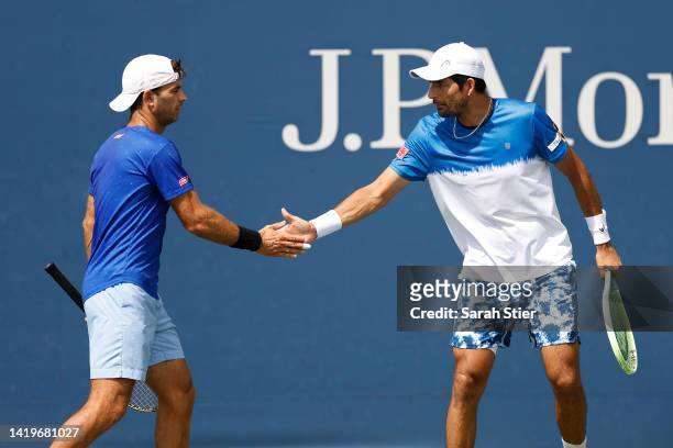 Marcelo Arevalo of El Salvador and Jean-Julien Rojer of Netherlands react to a point against John Peers of Australia and Alexi Popyrin of Australia...
