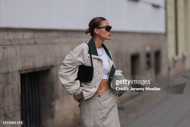 Alessa Winter wearing Viu Eyewear black shades, Frankie Shop beige oversized light jacket, Marco Polo long beige low waist skirt, Liu Jo black bag...