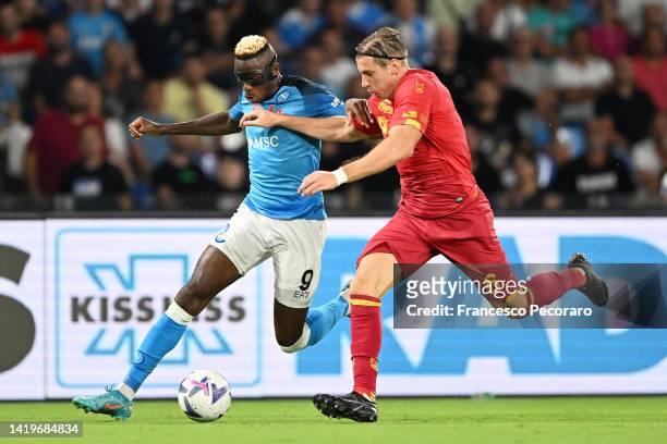 Victor Osimhen of Napoli is challenged by Federico Baschirotto of US Lecce during the Serie A match between SSC Napoli and US Lecce at Stadio Diego...