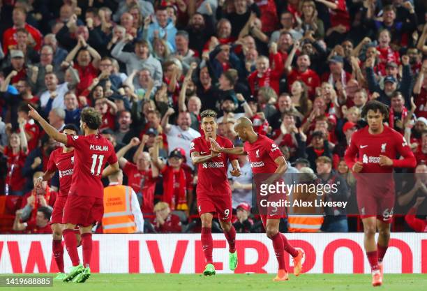 Roberto Firmino of Liverpool celebrates scoring their side's first goal with teammate Fabinho during the Premier League match between Liverpool FC...