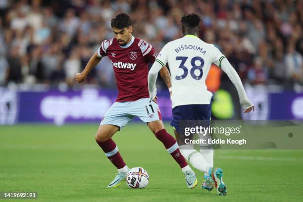 Lucas Paqueta of West Ham United is challenged by Yves Bissouma of Tottenham Hotspur during the Premier League match between West Ham United and...