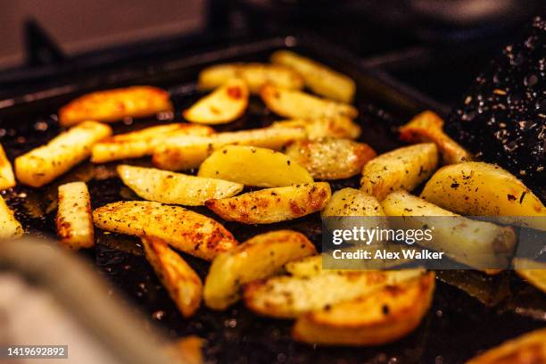 seasoned potato wedges on baking tray in oven - side dish stock pictures, royalty-free photos & images