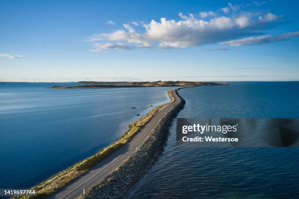 dam to remote island - danemark stock pictures, royalty-free photos & images