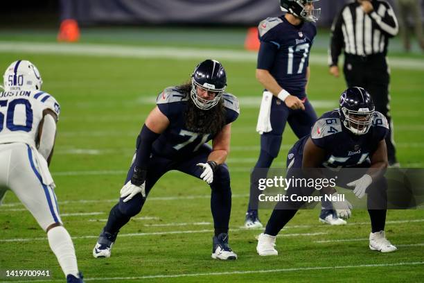 Dennis Kelly of the Tennessee Titans and guard Nate Davis get set on the line of scrimmage during an NFL game against the Indianapolis Colts,...