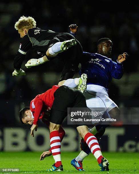 Kasper Schmeichel of Leicester City is taken out by Greg Cunningham of Nottingham Forest during the npower championship match between Leicester City...