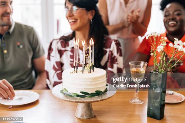 a view of a beautifully arranged birthday cake with lit candles - happy birthday flowers images stock pictures, royalty-free photos & images