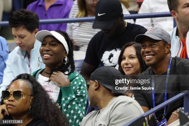 Venus Williams, Erica Herman and Tiger Woods look on during the Women's Singles Second Round match between Anett Kontaveit of Estonia and Serena...