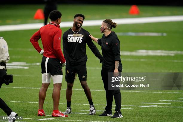 Emmanuel Sanders of the New Orleans Saints, Kendrick Bourne of the San Francisco 49ers, and Offensive Assistant coach Katie Sowers speak prior to an...