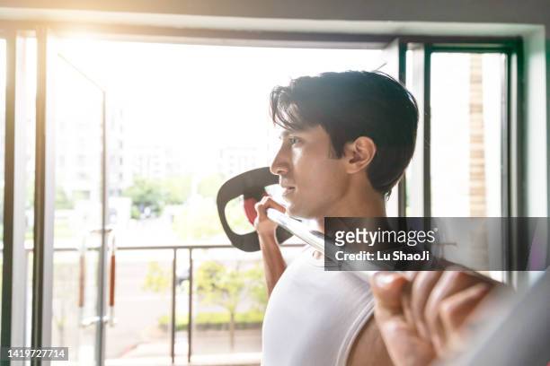young people do strength training in the gym. - gym fashion stock pictures, royalty-free photos & images