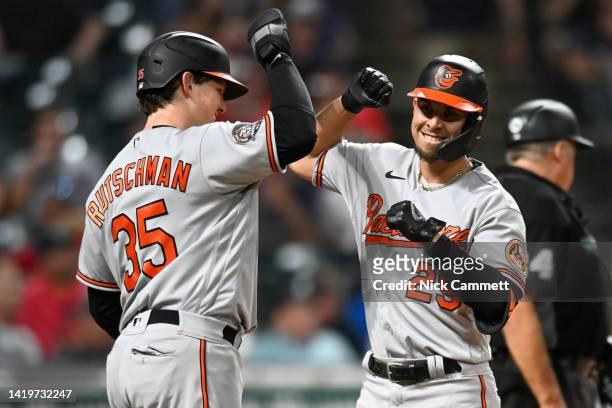 Adley Rutschman and Ramón Urías of the Baltimore Orioles celebrate scoring on a two-run home run by Urías during the eighth inning at Progressive...