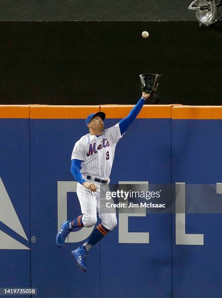 Brandon Nimmo of the New York Mets makes a catch at the wall on a ball off the bat of Justin Turner of the Los Angeles Dodgers in the seventh inning...