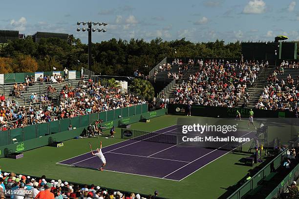 Andy Murray of Great Britain serves in his match against Gilles Simon of France at the Grandstand court on day 9 of the Sony Ericsson Open at Crandon...