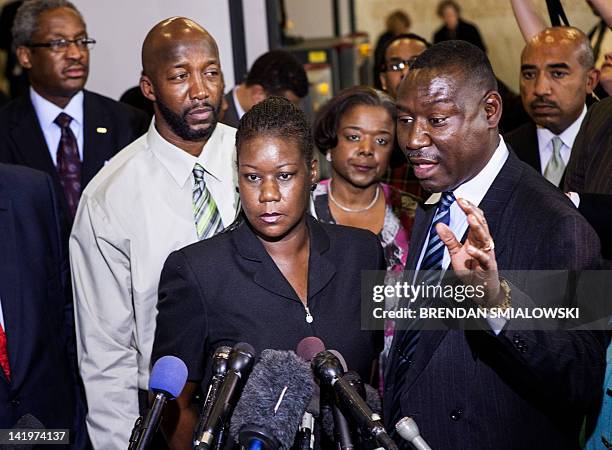 Sybrina Fulton and Tracy Martin , parents of Trayvon Martin, listen while their friend and lawyer Benjamin Crump speaks to the press after a forum of...