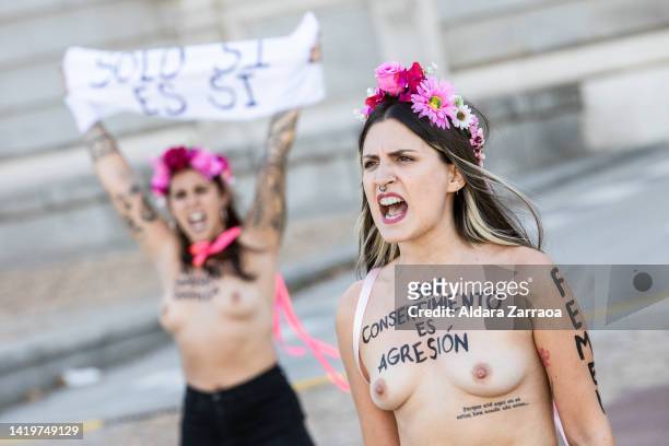 Member of the women's rights organization Femen protests with the slogan "Without consent, it is aggression" written on her chest in front of the...