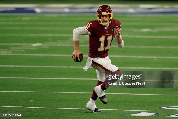 Alex Smith of the Washington Football Team runs the ball during an NFL game against the Dallas Cowboys at AT&T Stadium on November 26, 2020 in...