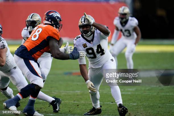 Cameron Jordan of the New Orleans Saints attempts to move past the blocking Denver Broncos offensive tackle Demar Dotson during an NFL game on...