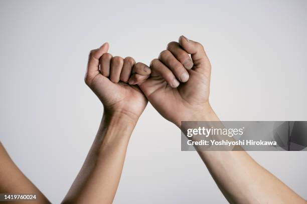 asian surfer's fingers photographed in studio - eid stock-fotos und bilder