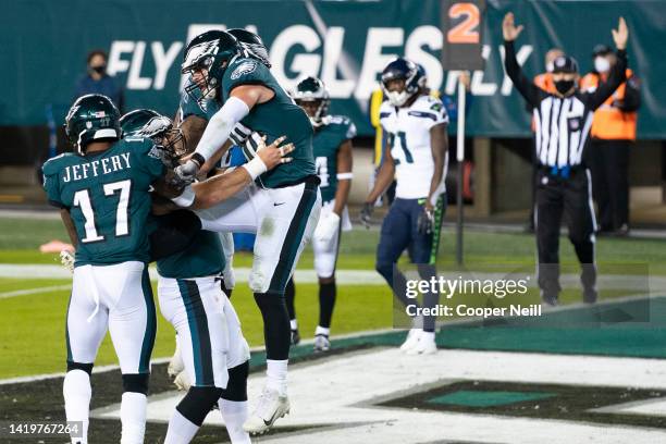 Dallas Goedert of the Philadelphia Eagles celebrates with teammates in the end zone during an NFL game against the Seattle Seahawks on November 30,...