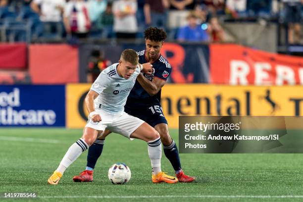 Chris Mueller of Chicago Fire FC attempts to control the ball as Brandon Bye of New England Revolution pressures during a game between Chicago Fire...