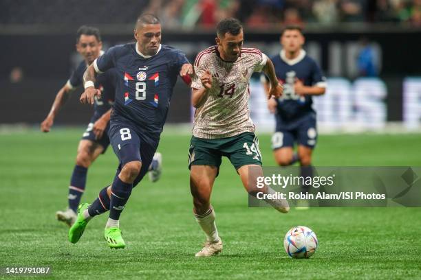 Richard Ortíz of Paraguay and Luis Chávez of Mexico fight for a loose ball during a game between Paraguay and Mexico at Mercedes-Benz Stadium on...