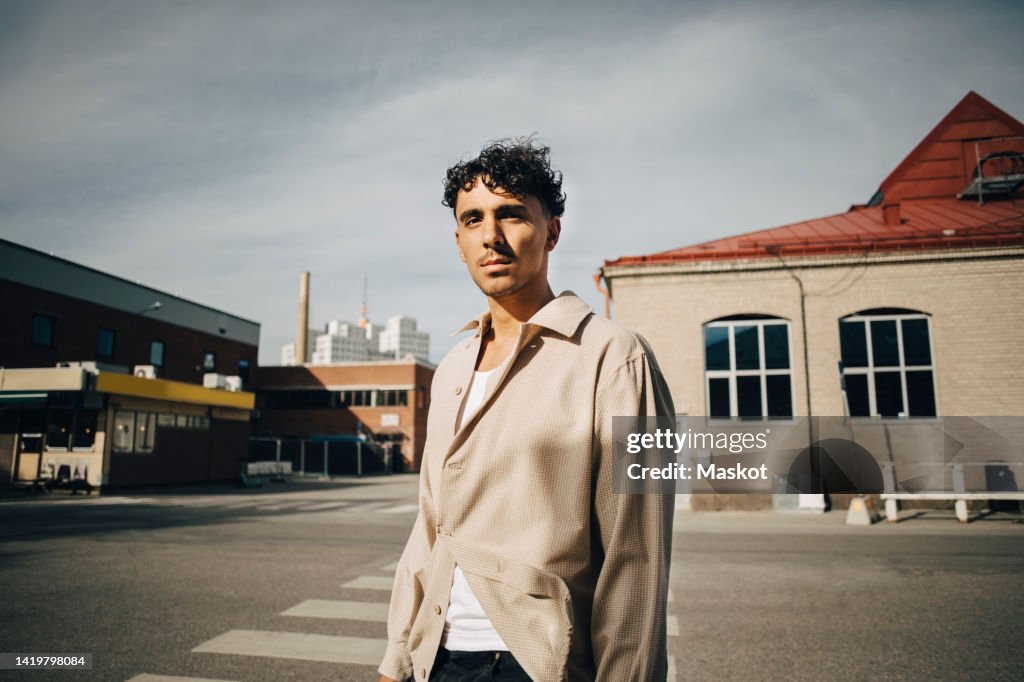 Portrait of confident young man standing on street