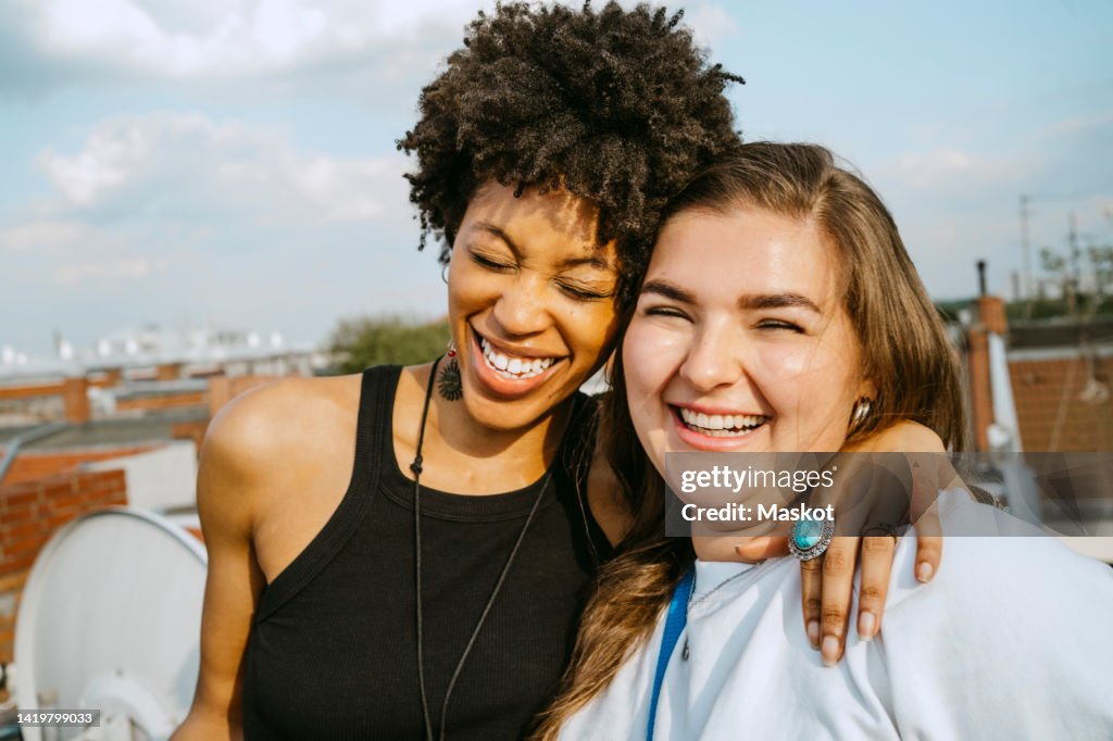 Cheerful multiracial young female friends enjoying during sunny day