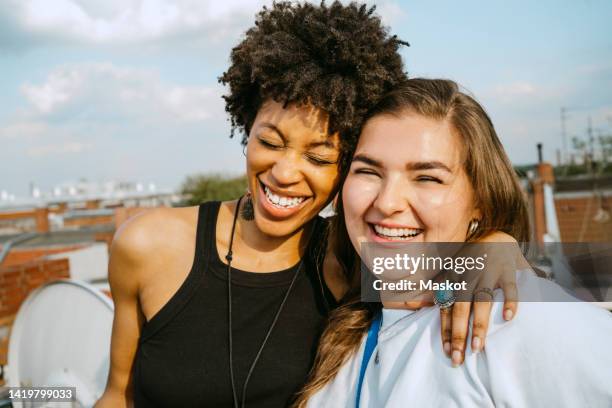 cheerful multiracial young female friends enjoying during sunny day - women friends stock pictures, royalty-free photos & images