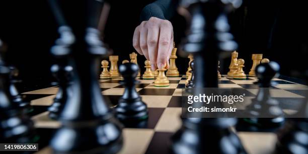 woman's hand playing chess - rook chess piece stock pictures, royalty-free photos & images