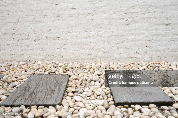 stepping stones and white brick wall - stepping stone top view stock pictures, royalty-free photos & images