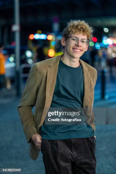 laughing young man in front of urban background - handsome teen boy outdoors stock pictures, royalty-free photos & images