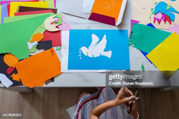 little girl cutting paper - child cutting card stock pictures, royalty-free photos & images