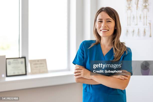 woman nurse wearing doctor uniform with smiling face - female nurse stock pictures, royalty-free photos & images