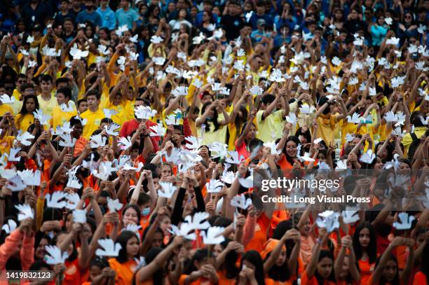 Choir made up of more than 10000 children wave peace doves as they sing during the world's largest concert for peace played by Bogota's Symphonic...