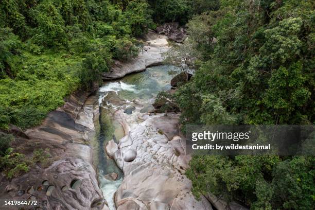 aerial view of the smoothly eroded granite boulders at the babinda boulders picnic ground. - cairns aerial stock pictures, royalty-free photos & images