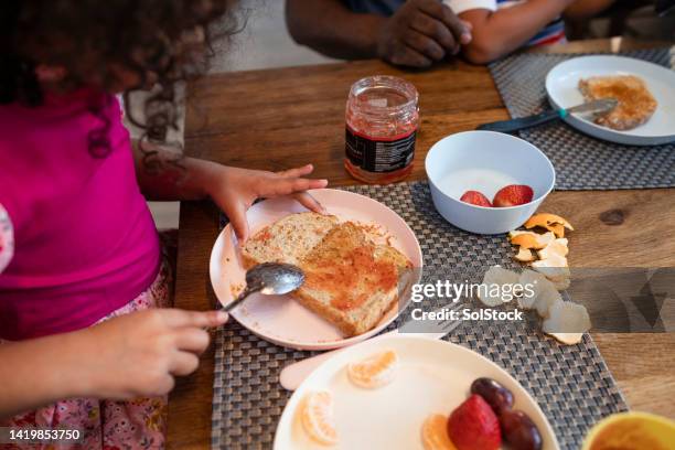 spreading jam on toast - spreading stock pictures, royalty-free photos & images