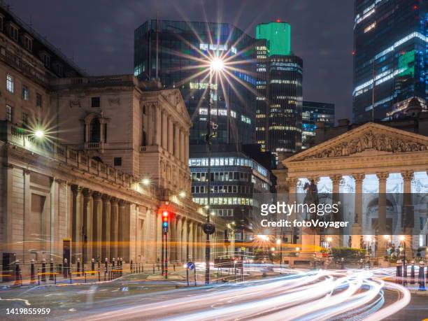 london bank of england overlooked by city skyscrapers at night - banking district stock pictures, royalty-free photos & images