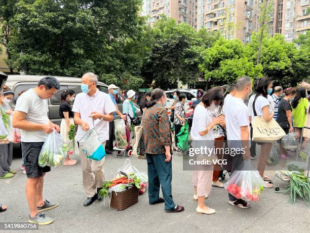 People line up to buy vegetables in preparation for a COVID-19 lockdown on September 1, 2022 in Chengdu, Sichuan Province of China. Chengdu will...