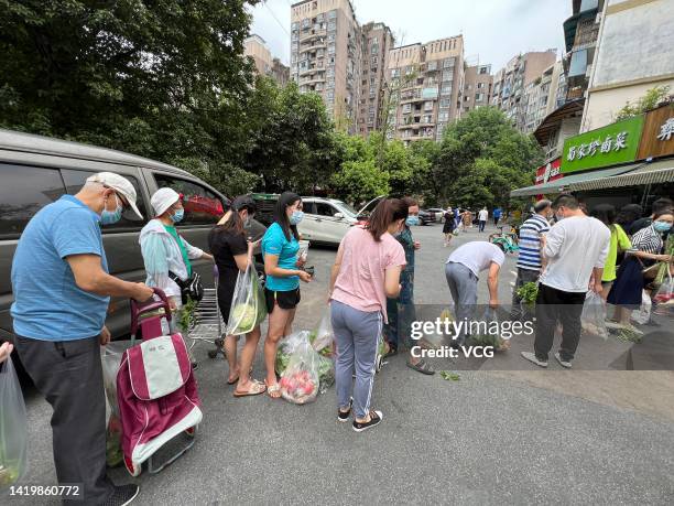 People line up to buy vegetables in preparation for a COVID-19 lockdown on September 1, 2022 in Chengdu, Sichuan Province of China. Chengdu will...