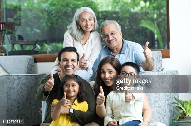 multi-generation family giving thumbs up gesture - indian ethnicity imagens e fotografias de stock