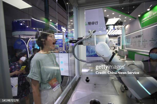 Throat swab nucleic acid sampling robot demonstrates its skills during the 2022 World Artificial Intelligence Conference at the Shanghai World Expo...