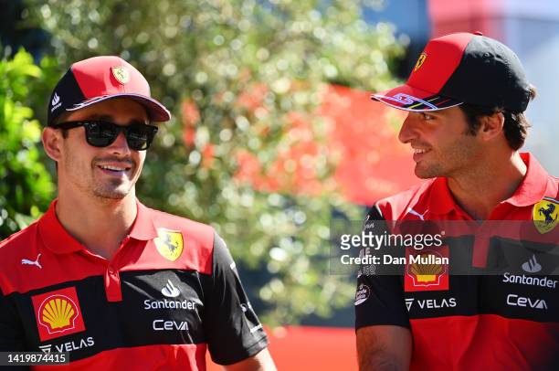 Charles Leclerc of Monaco and Ferrari and Carlos Sainz of Spain and Ferrari look on in the Paddock during previews ahead of the F1 Grand Prix of The...