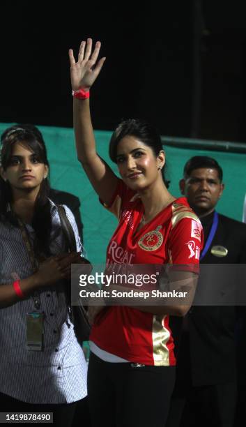 Bollywood actress Katrina Kaif wearing the team dress of Royal Challengers walking and waves to spectators in the stadium in during and Indian...